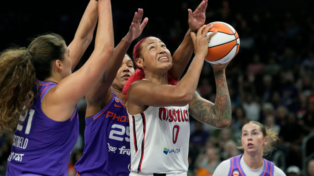 Washington Mystics center Shakira Austin (0) goes up for a shot against Phoenix Mercury forwards Maddy Westbeld (21) and Alyssa Thomas as Mercury guard Shay Ciezki, right, looks on during the second half of a WNBA basketball game, Thursday, Aug. 27, 2026, in Phoenix.